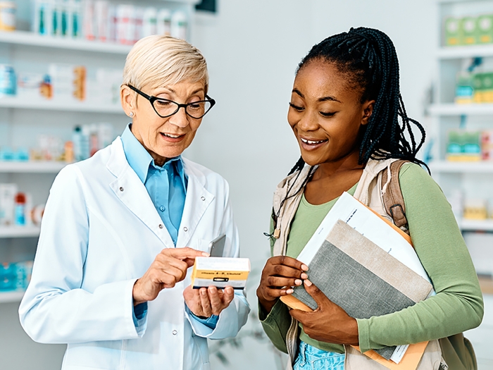 Pharmacist going over medication with patient or caregiver.