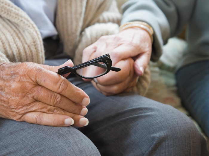 Older couple holding hands