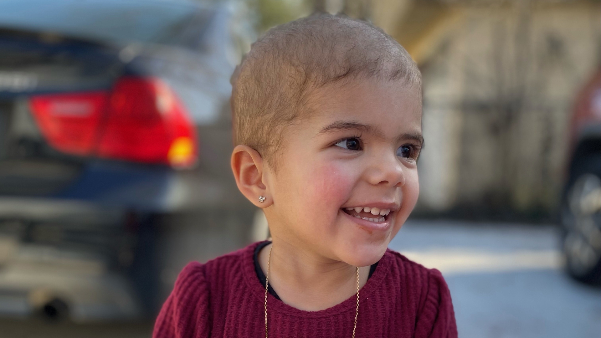 Toddler Martina smiling.